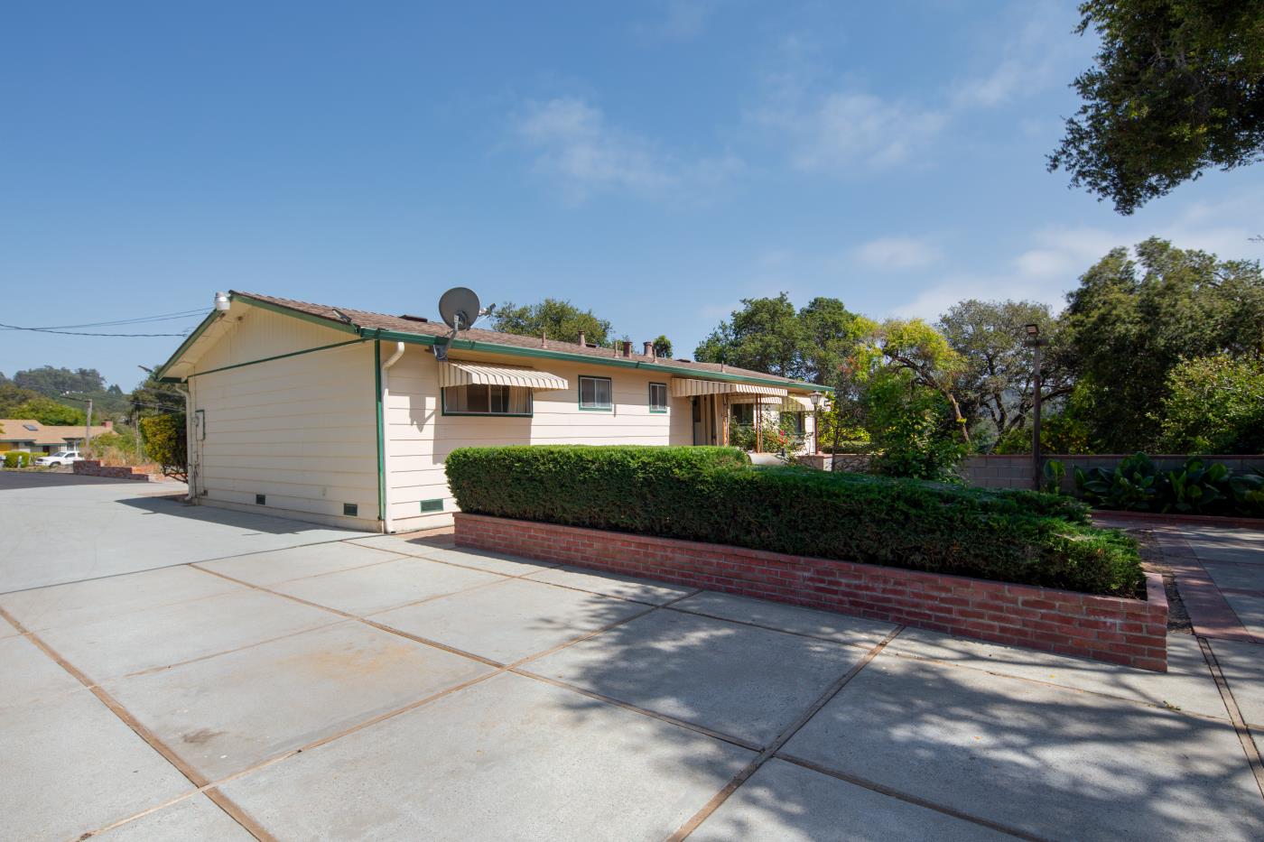 7600 Pine Tree Way Salinas, CA 93907 - Photo 17 of 43 a front view of a house with a yard and a garage