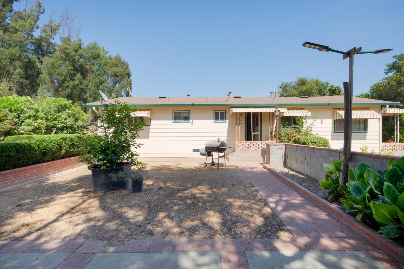 7600 Pine Tree Way Salinas, CA 93907 - Photo 19 of 43 a view of a patio with table and chairs potted plants and floor to ceiling window
