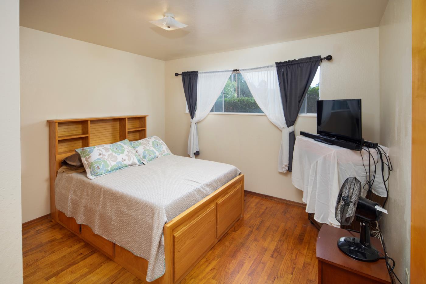 7600 Pine Tree Way Salinas, CA 93907 - Photo 42 of 43 a bedroom with a bed and a flat tv screen on the dresser