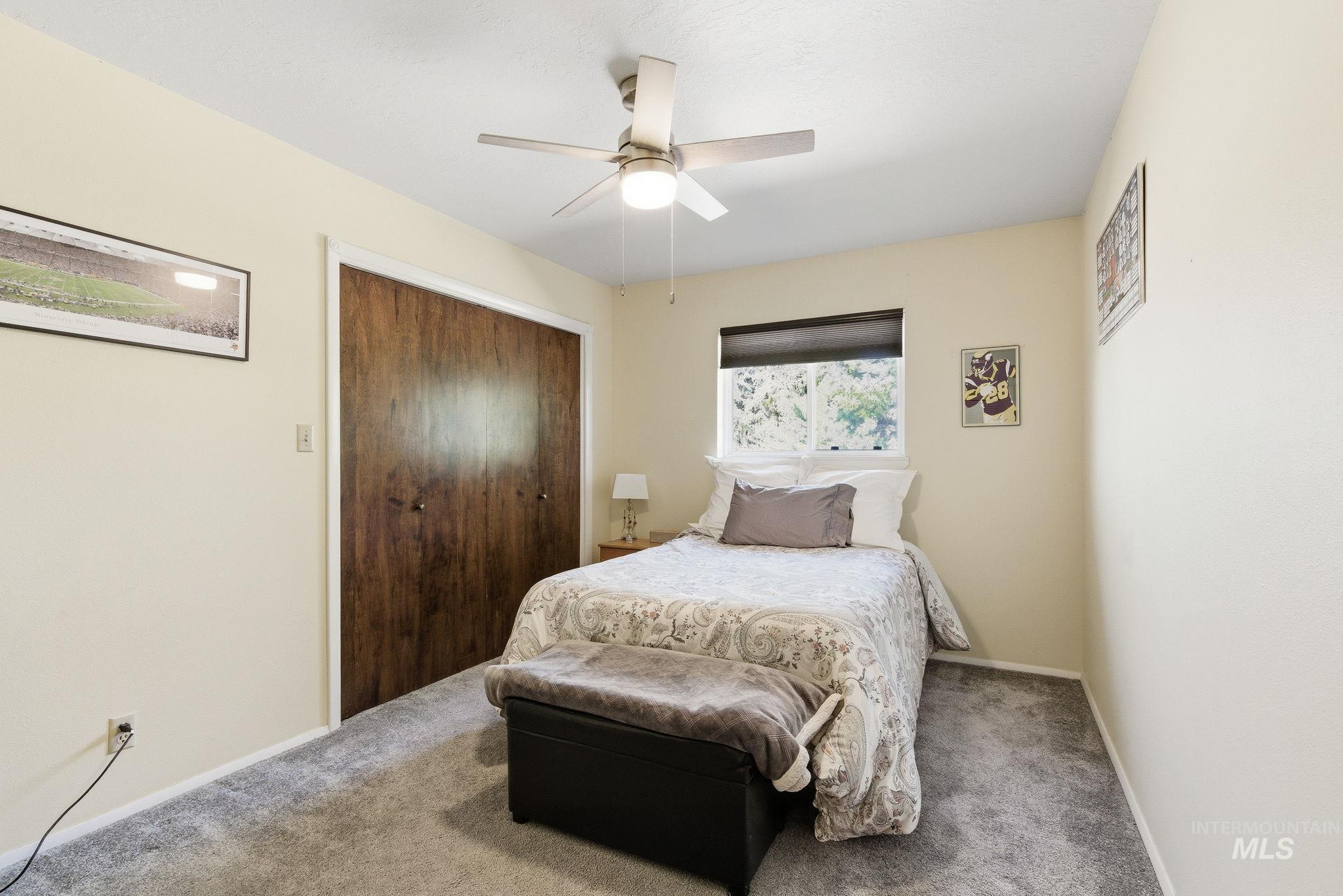 12055 West McMillan Road Boise, ID 83713 - Photo 19 of 42 Carpeted bedroom featuring ceiling fan and a closet
