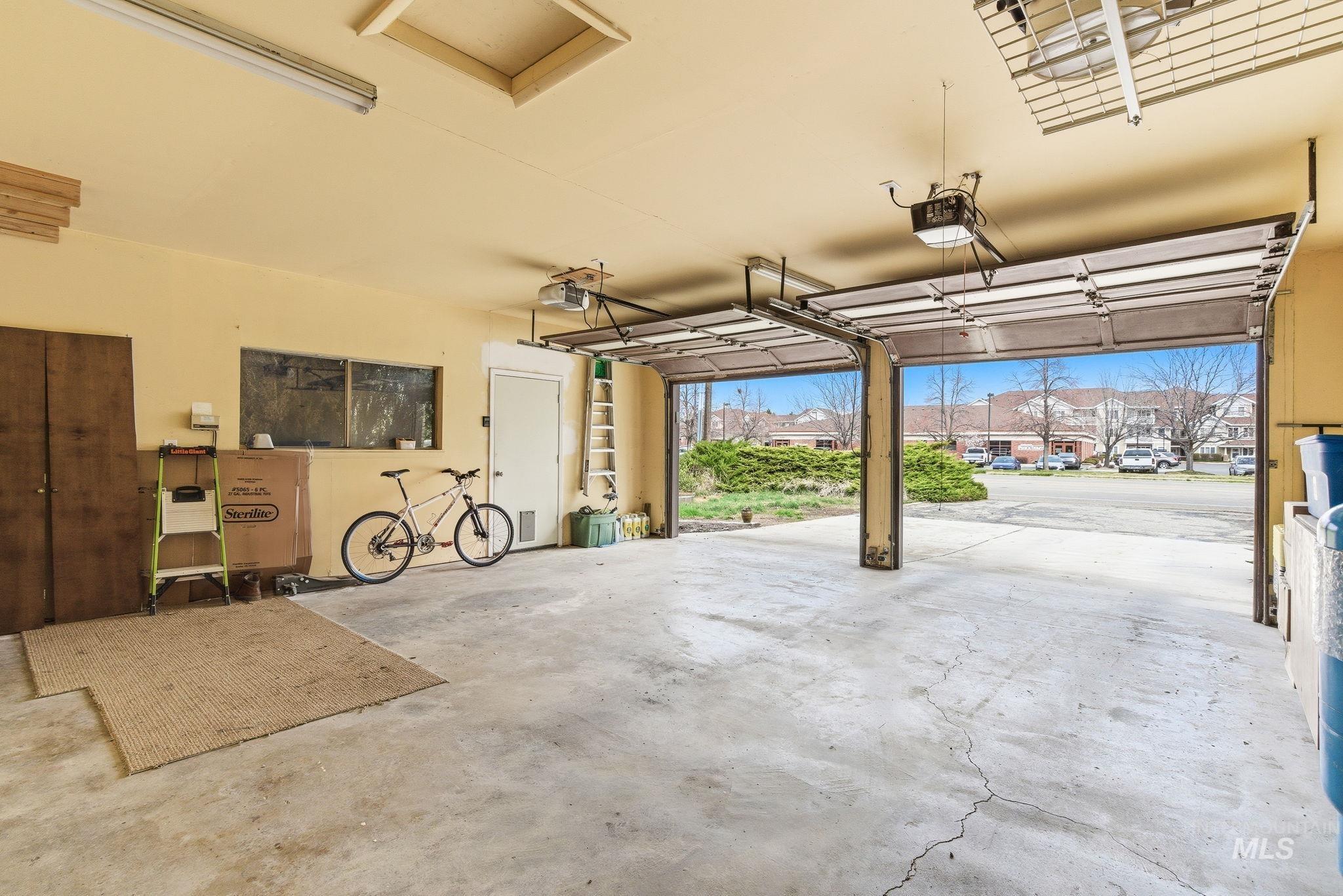 12055 West McMillan Road Boise, ID 83713 - Photo 20 of 42 Garage featuring a residential view and a garage door opener