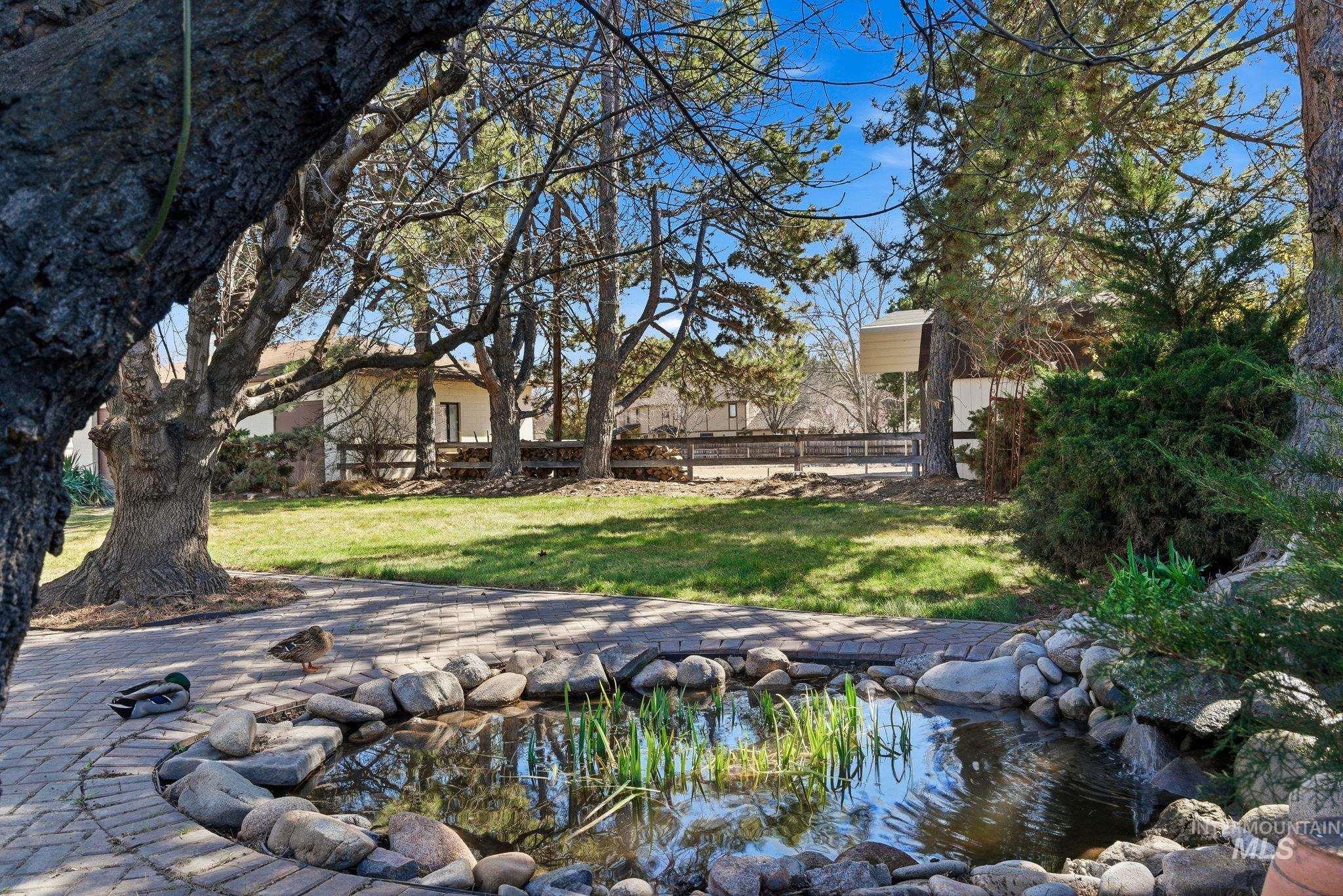 12055 West McMillan Road Boise, ID 83713 - Photo 22 of 42 View of yard featuring a small pond