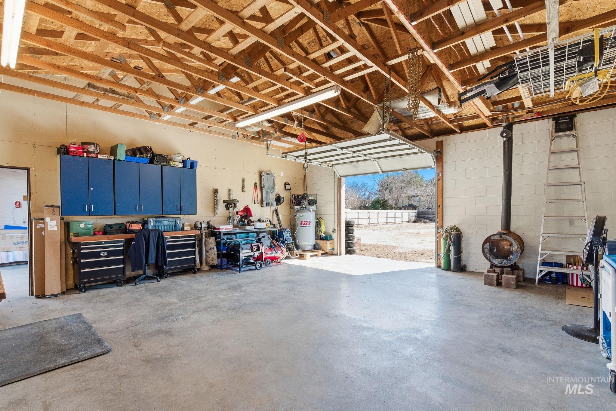 12055 West McMillan Road Boise, ID 83713 - Photo 35 of 42 Garage with concrete block wall and a workshop area