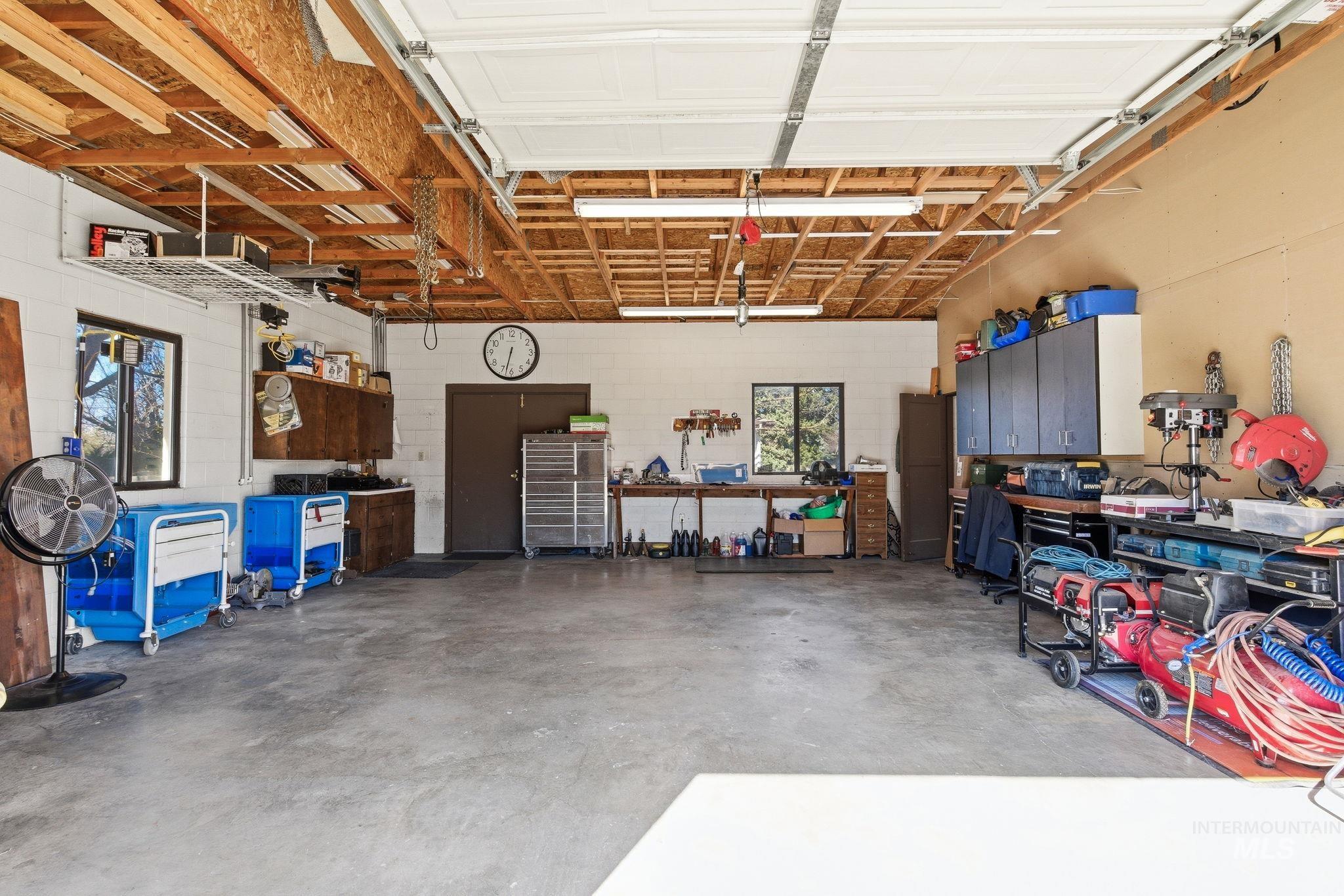 12055 West McMillan Road Boise, ID 83713 - Photo 36 of 42 Garage featuring concrete block wall and a workshop area