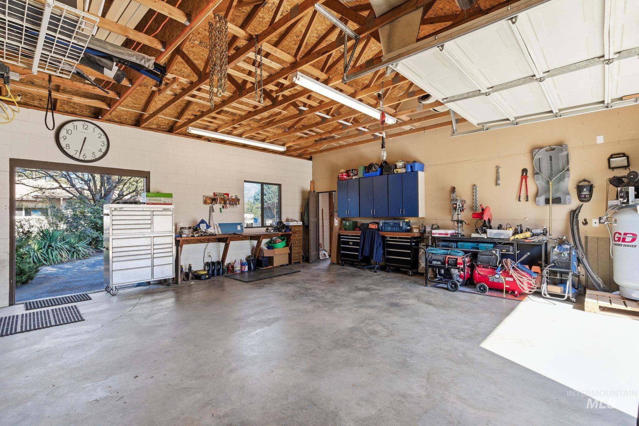 12055 West McMillan Road Boise, ID 83713 - Photo 38 of 42 Garage with a workshop area and concrete block wall