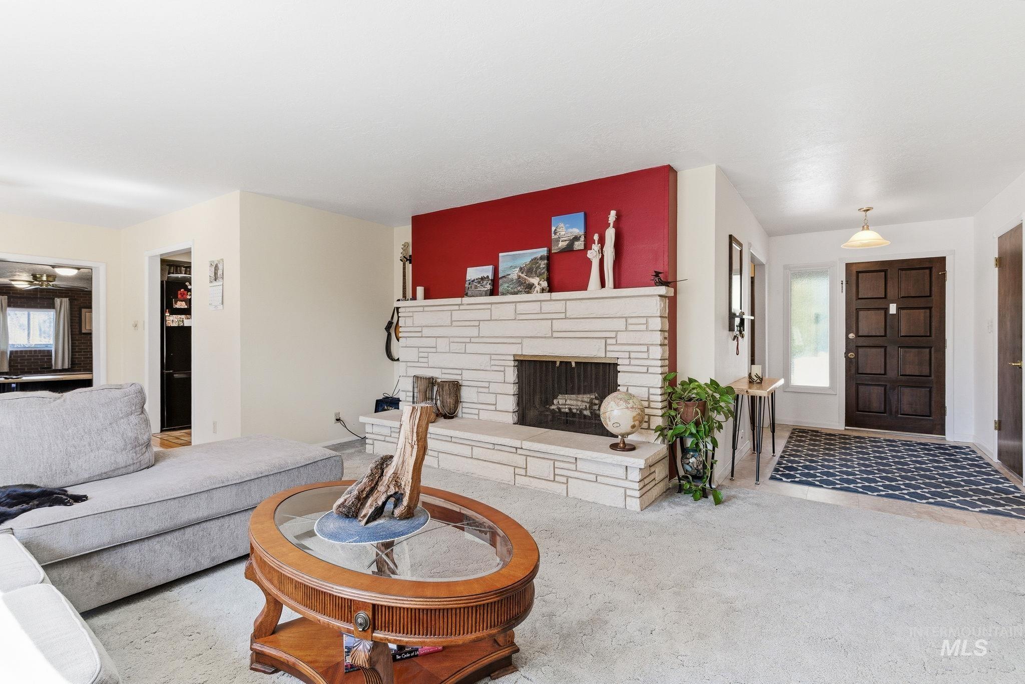 12055 West McMillan Road Boise, ID 83713 - Photo 4 of 42 Carpeted living area with healthy amount of natural light and a fireplace
