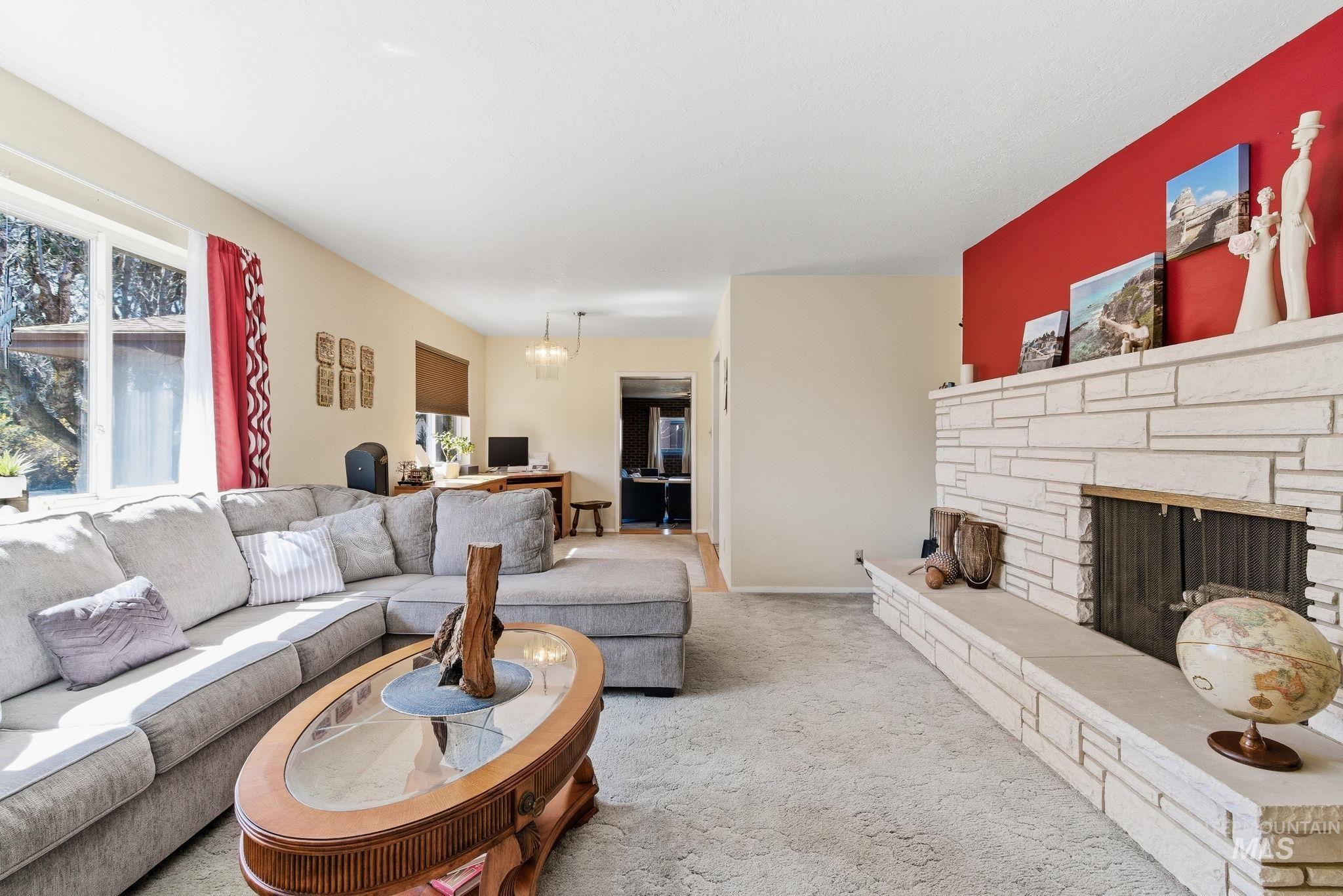 12055 West McMillan Road Boise, ID 83713 - Photo 5 of 42 Carpeted living room with a fireplace and baseboards