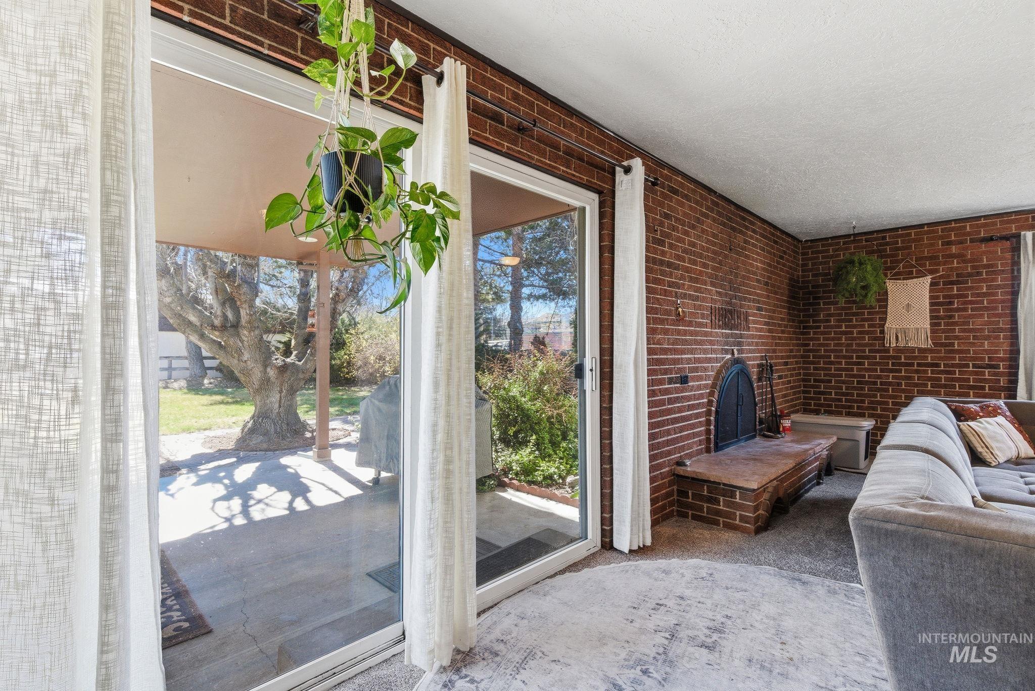 12055 West McMillan Road Boise, ID 83713 - Photo 8 of 42 Entryway featuring carpet floors and brick wall