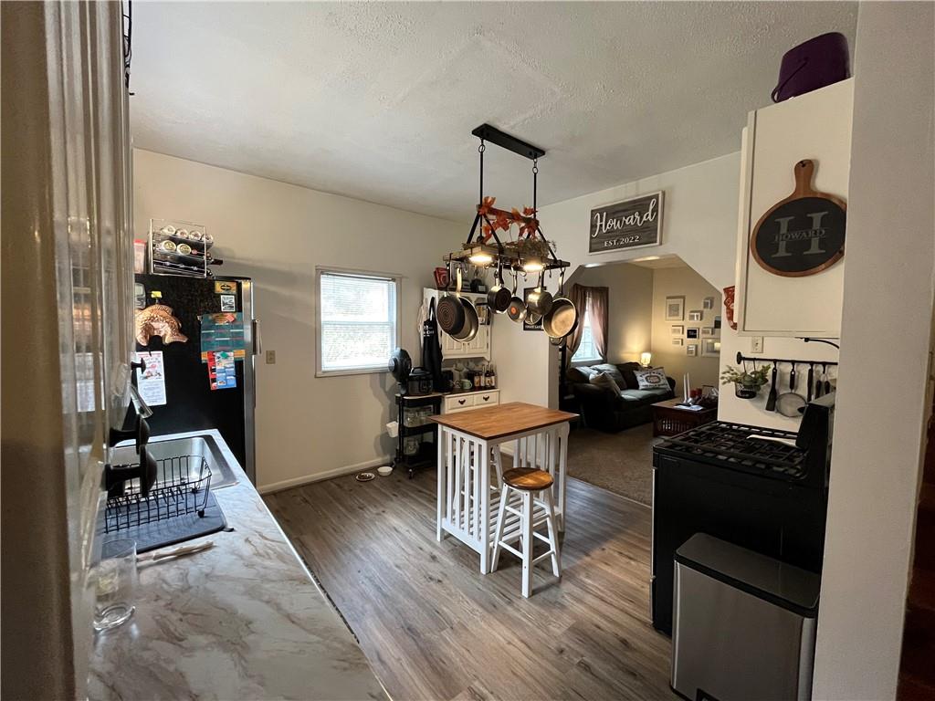 197 Oak Road Holbrook, PA 15341 - Photo 7 of 17 a view of a dining room with furniture and wooden floor