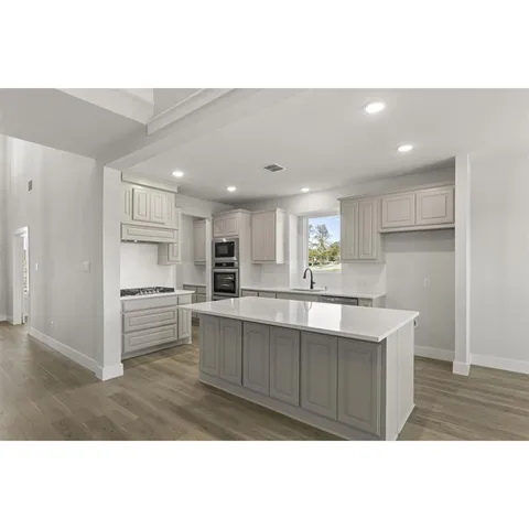 a view of kitchen with kitchen island sink and refrigerator