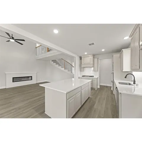 a kitchen with granite countertop a stove and a sink