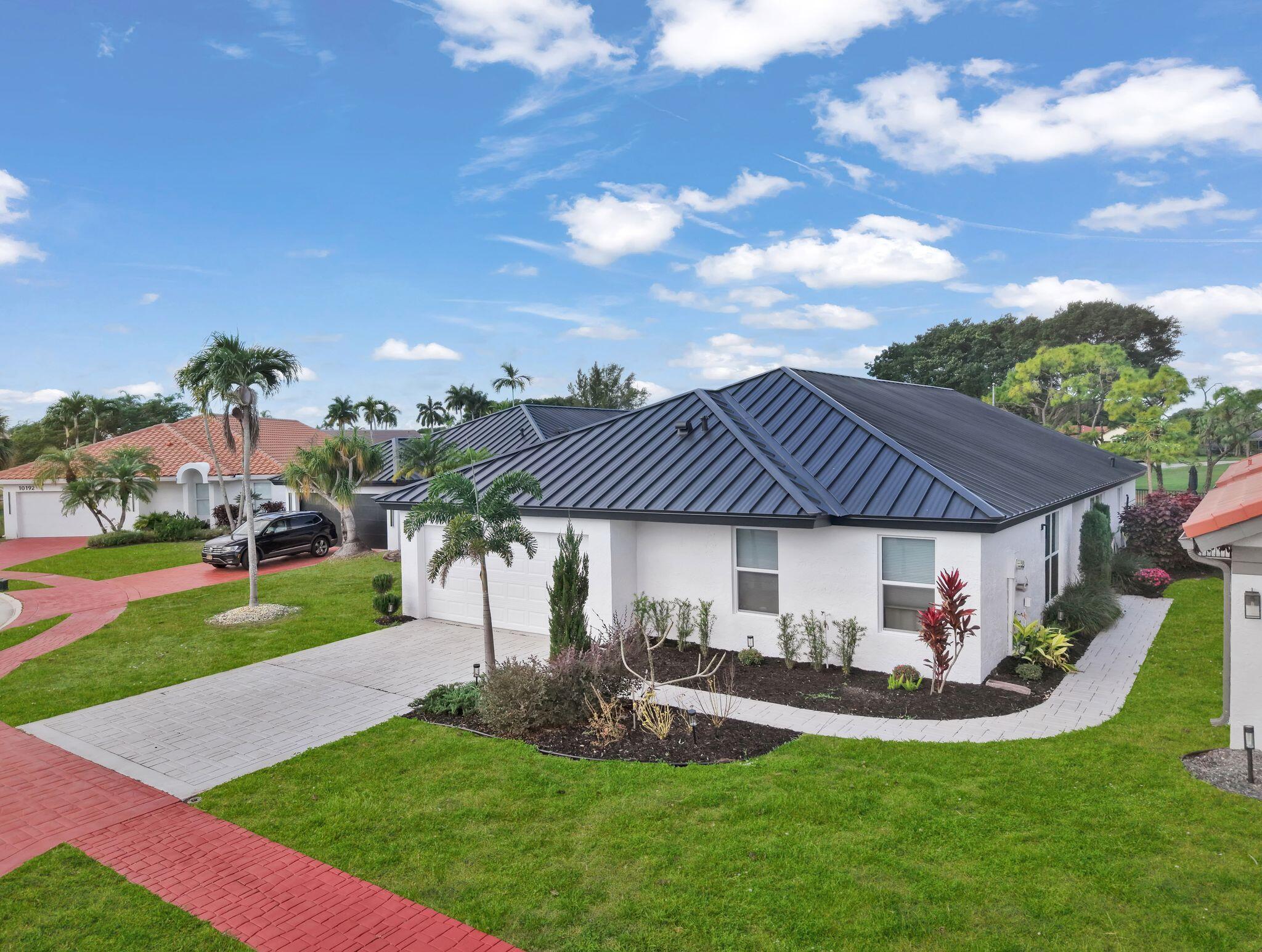 10208 Sunset Bend Drive Boca Raton, FL 33428 - Photo 1 of 40 a view of a house with a yard porch and sitting area