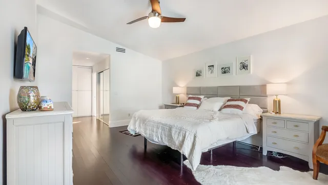 a bedroom with a bed and a dresser in it