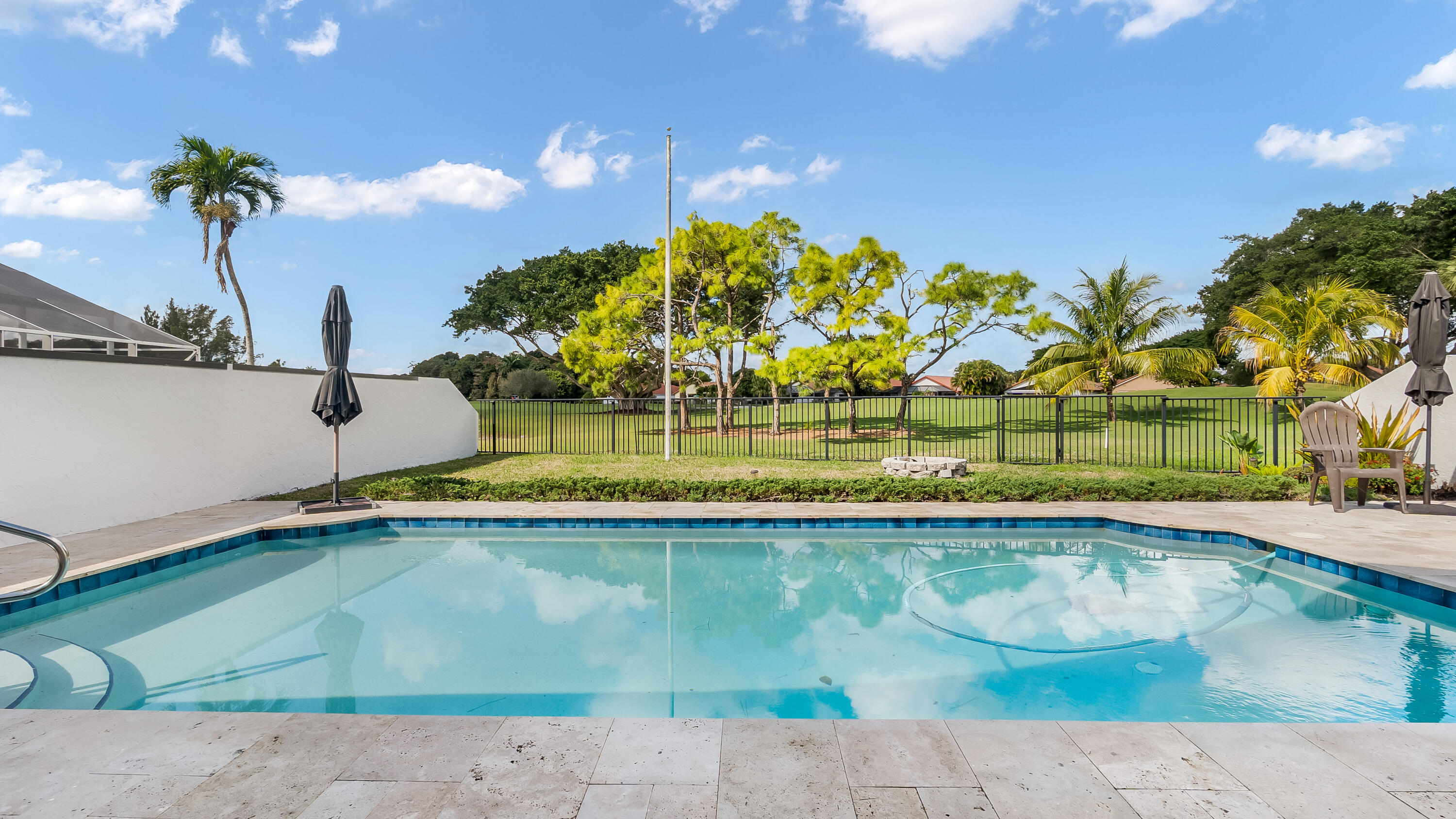 10208 Sunset Bend Drive Boca Raton, FL 33428 - Photo 36 of 40 a view of a swimming pool with a yard