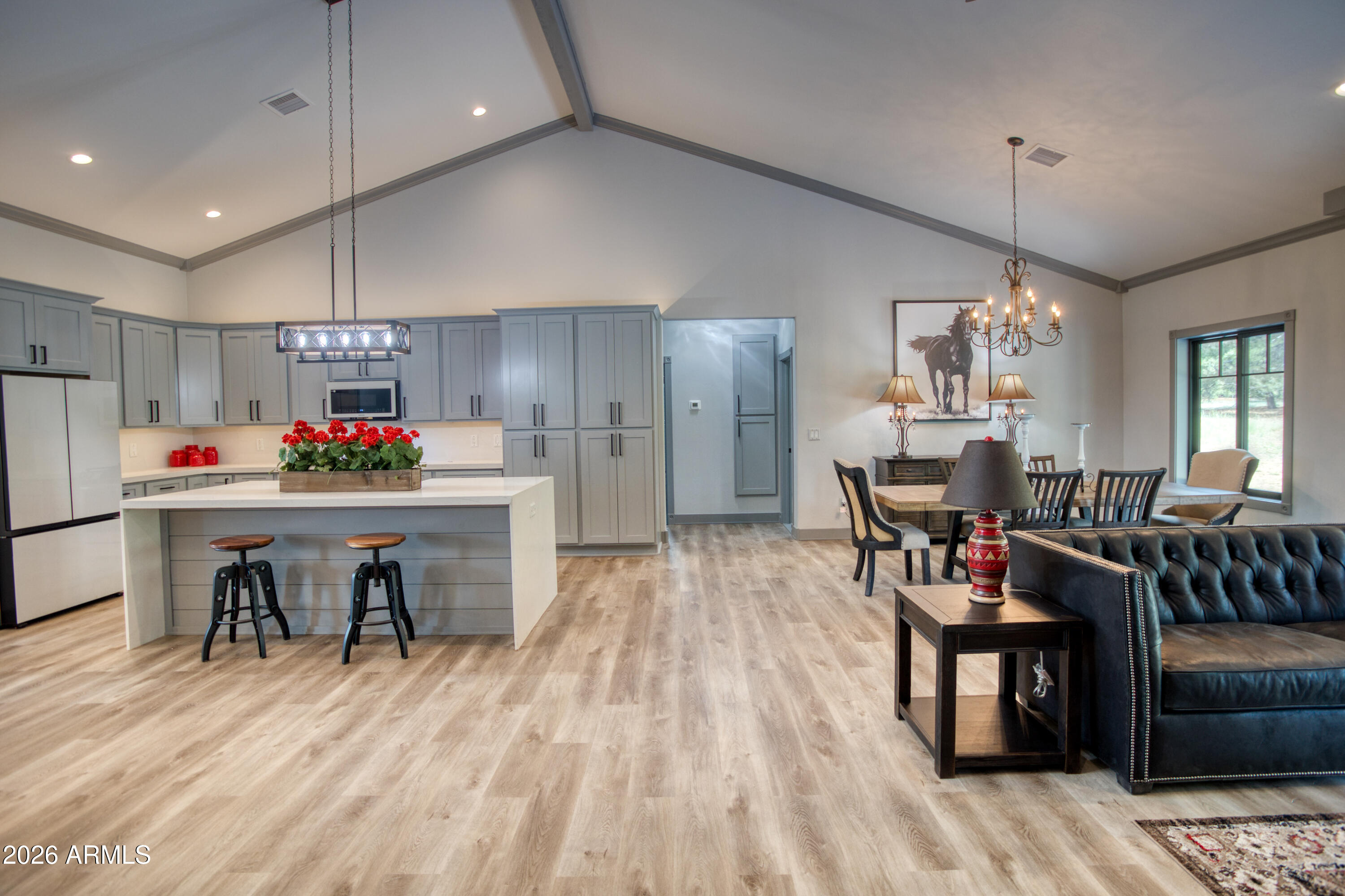 2281 West Edgewater Show Low, AZ 85901 - Photo 13 of 46 a kitchen with kitchen island a dining table chairs cabinets and stainless steel appliances