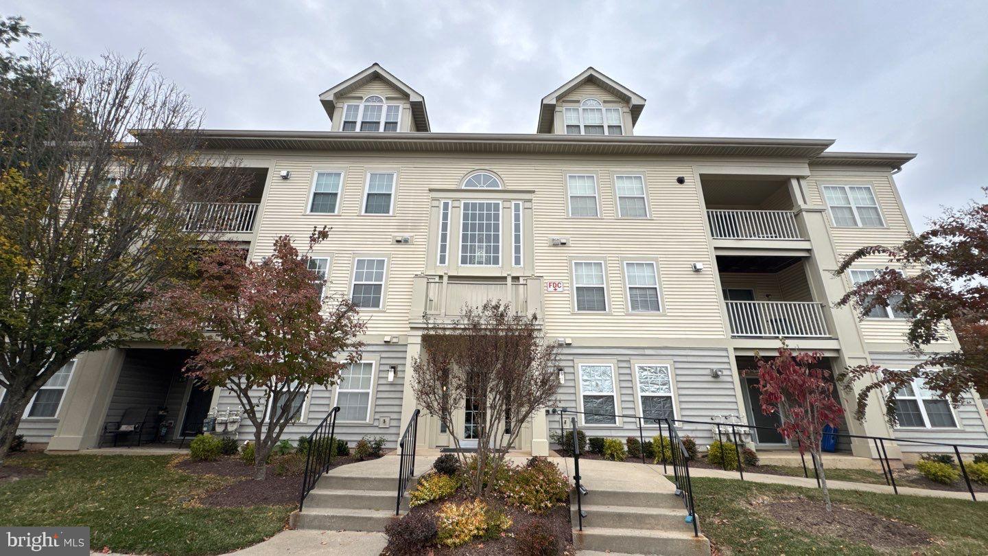 9150 Gracious End Court, Unit 103 Columbia, MD 21046 - Photo 1 of 18 a front view of a house with a yard