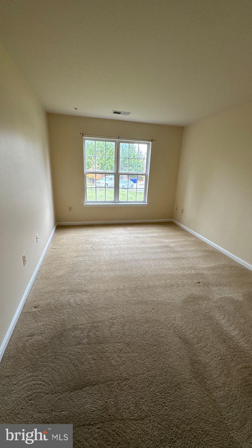 9150 Gracious End Court, Unit 103 Columbia, MD 21046 - Photo 11 of 18 en empty room with windows