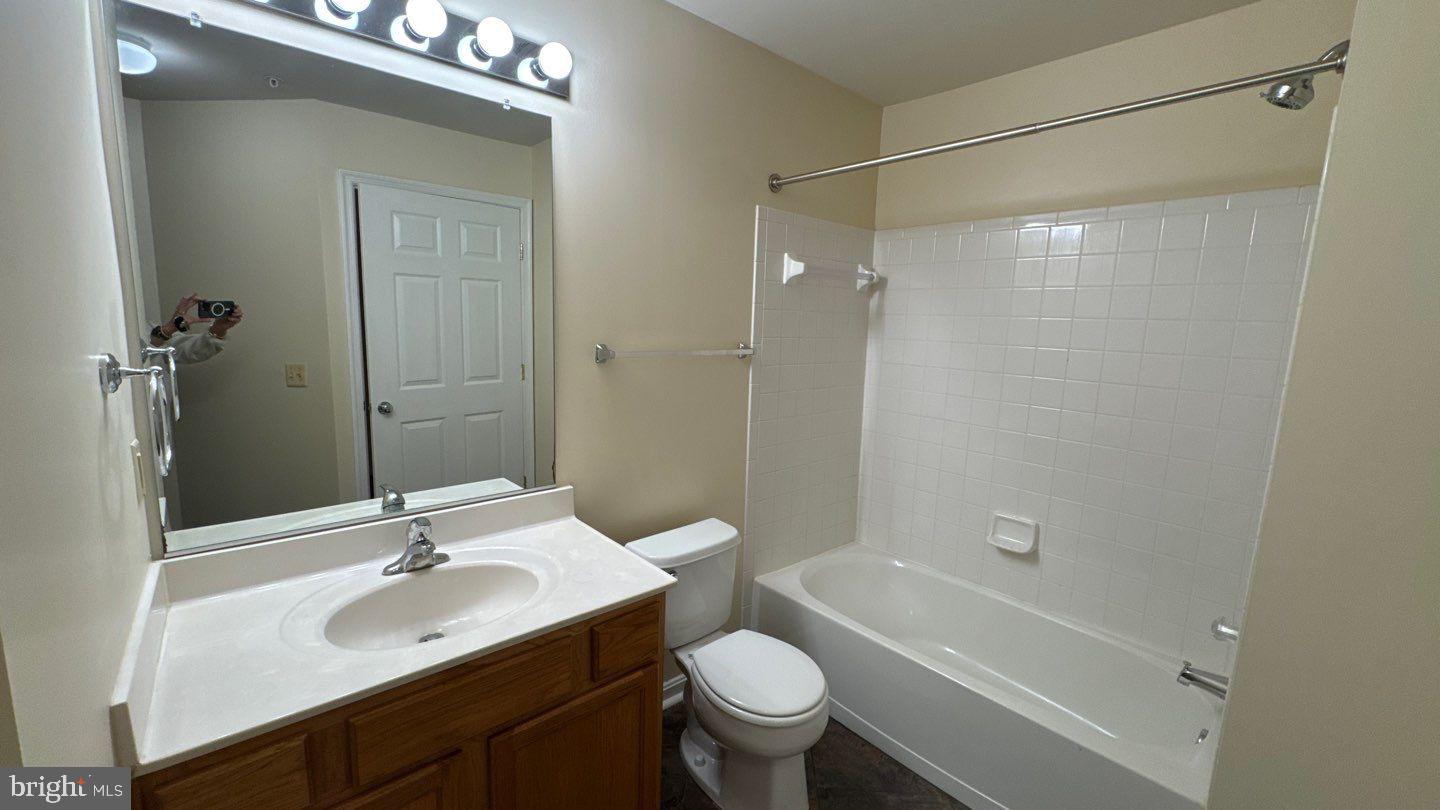 9150 Gracious End Court, Unit 103 Columbia, MD 21046 - Photo 13 of 18 a bathroom with a sink toilet and shower