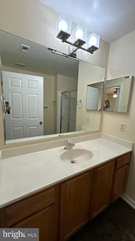 a bathroom with a glass shower door
