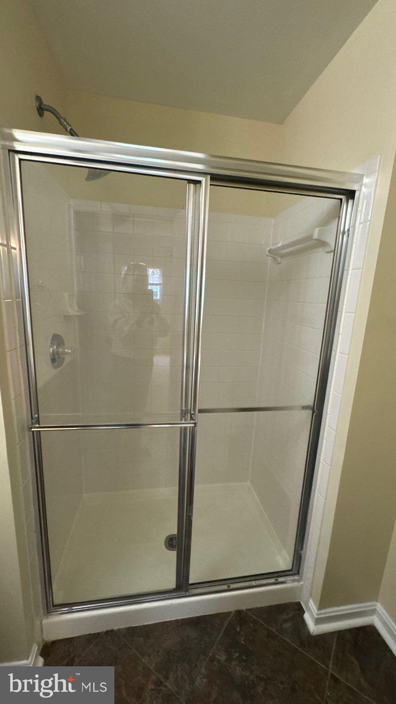 9150 Gracious End Court, Unit 103 Columbia, MD 21046 - Photo 16 of 18 a bathroom with a glass shower door