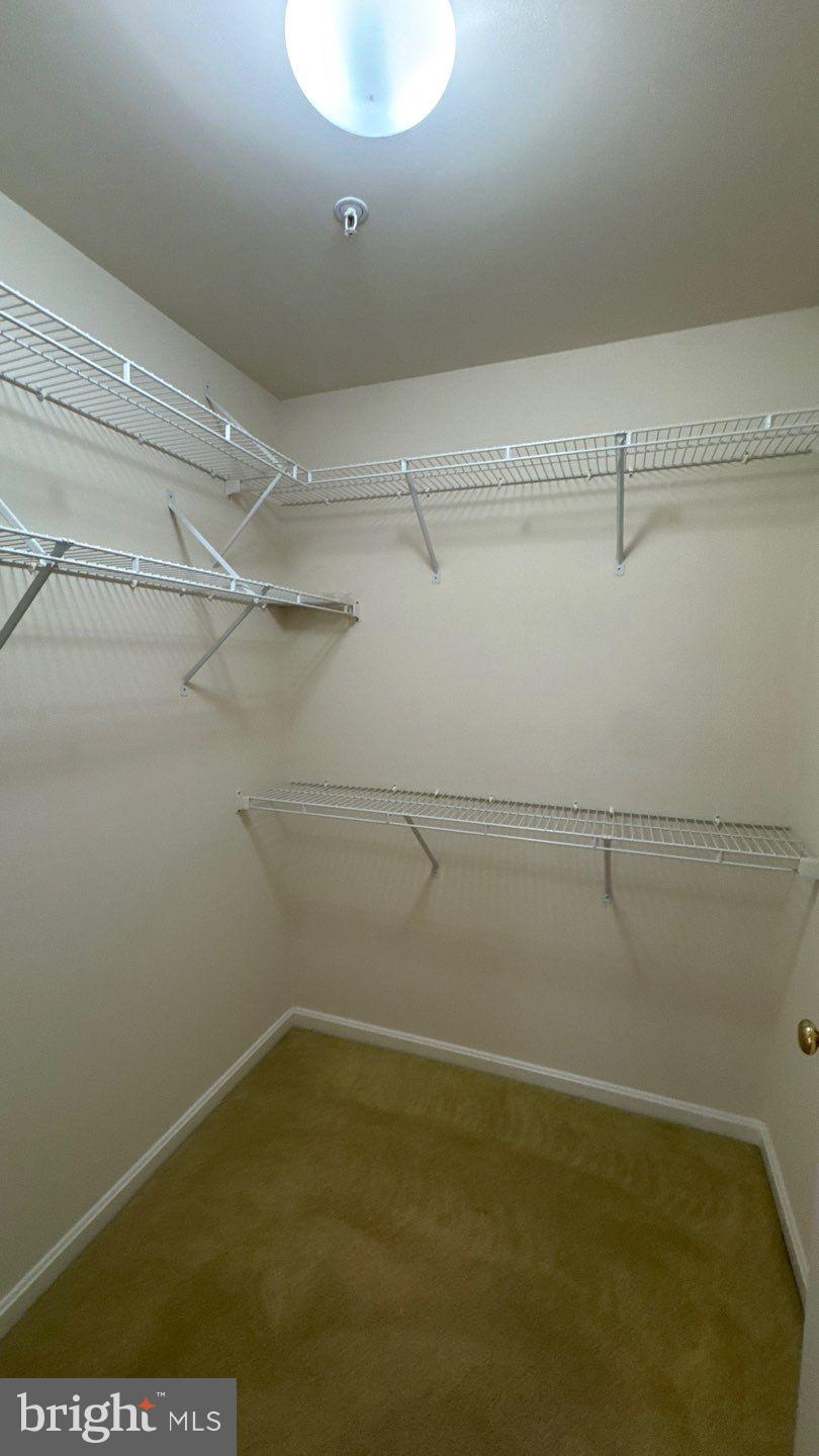 9150 Gracious End Court, Unit 103 Columbia, MD 21046 - Photo 17 of 18 a view of a room with racks on the wall