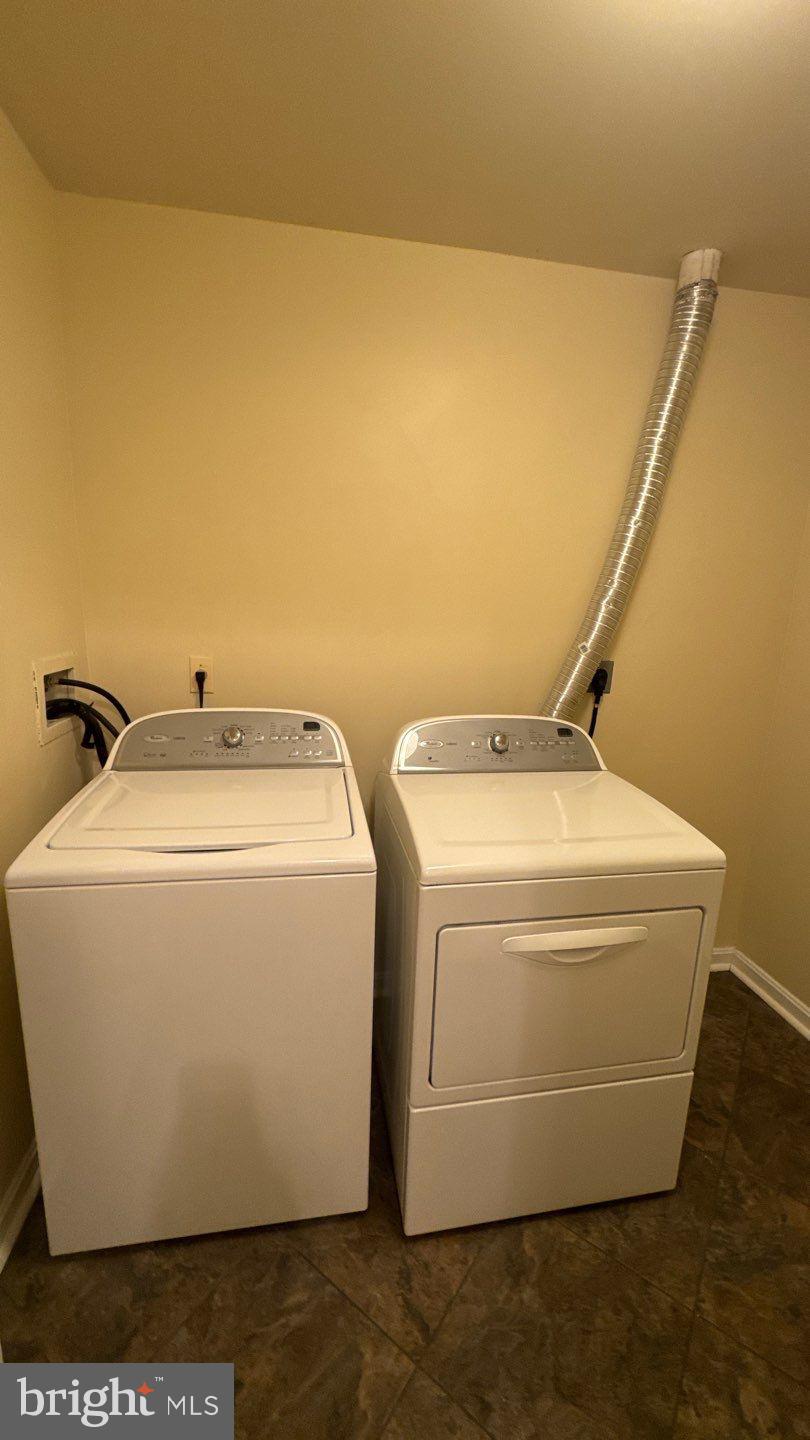 9150 Gracious End Court, Unit 103 Columbia, MD 21046 - Photo 18 of 18 a utility room with dryer and washer
