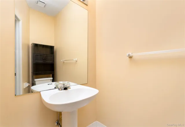 an empty room with a window and a ceiling fan