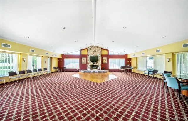 a front view of a house with a yard and potted plants