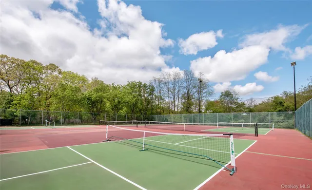 a view of a house with a yard and large trees