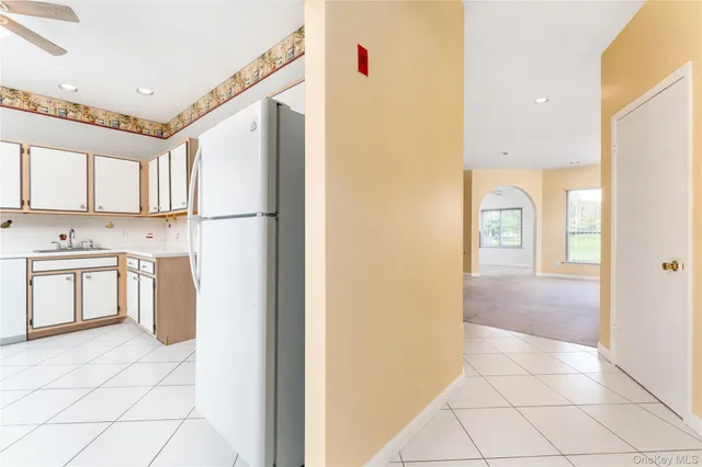 a kitchen with granite countertop white cabinets and white appliances