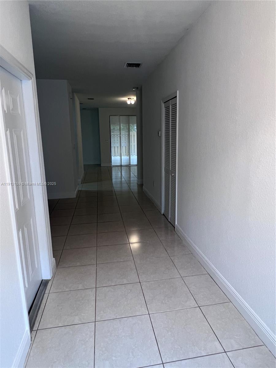 9801 Northwest 9th Street, Unit 9801 Miami, FL 33172 - Photo 3 of 7 a view of hallway with a window