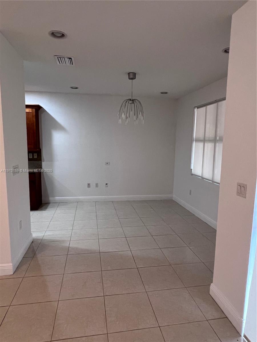 9801 Northwest 9th Street, Unit 9801 Miami, FL 33172 - Photo 4 of 7 a view of an empty room with a window