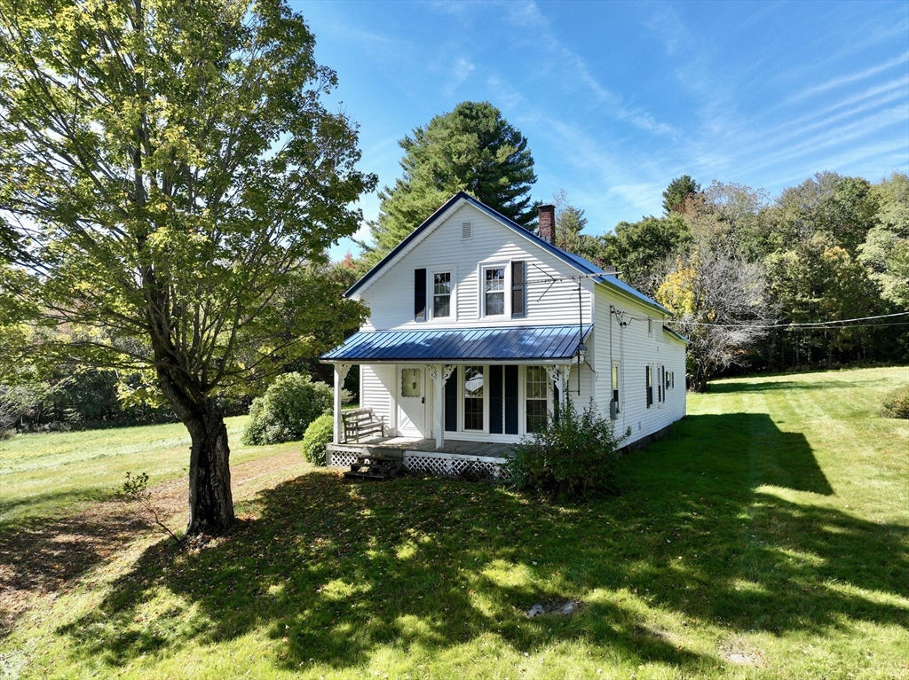 146 Potter Road Rowe, MA 01367 - Photo 1 of 40 a front view of a house with garden