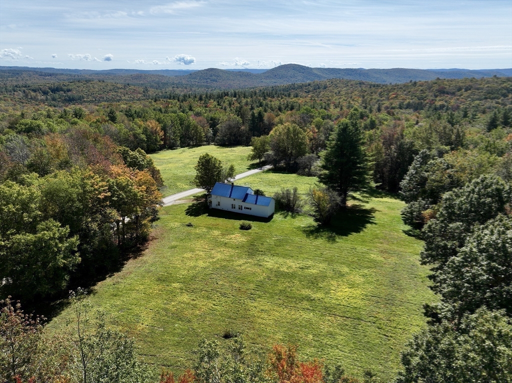 146 Potter Road Rowe, MA 01367 - Photo 3 of 40 a large mountain with trees in the background