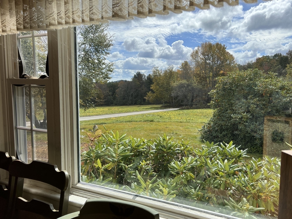 146 Potter Road Rowe, MA 01367 - Photo 5 of 40 a view of a balcony with floor to ceiling windows with wooden floor