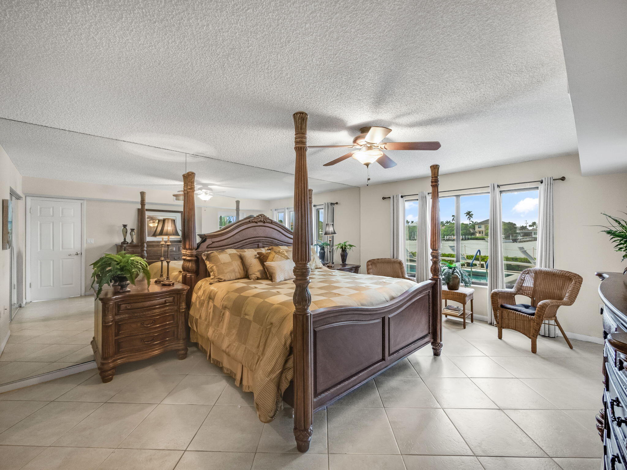 3525 South Ocean Boulevard, Unit 107 South Palm Beach, FL 33480 - Photo 11 of 21 a bedroom with a bed and large window