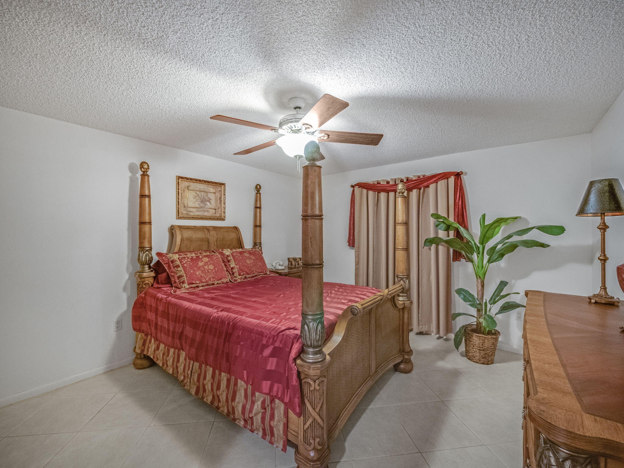 3525 South Ocean Boulevard, Unit 107 South Palm Beach, FL 33480 - Photo 16 of 21 a bedroom with bed and a potted plant