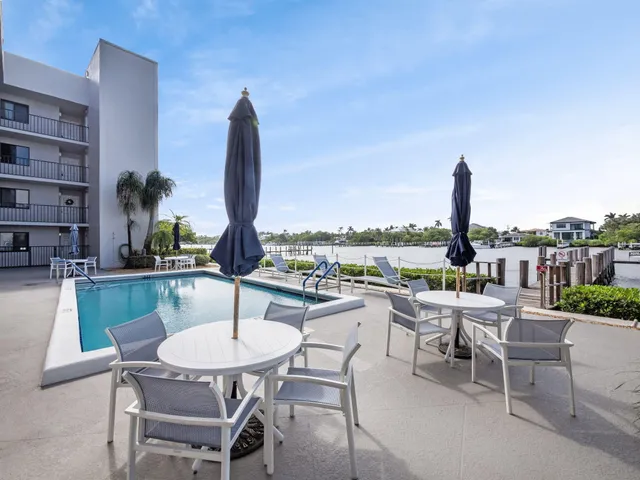 a dining room with furniture and a floor to ceiling window