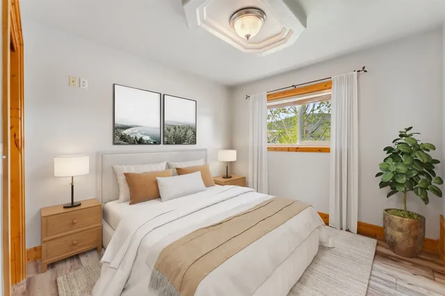 a bedroom with a bed and a potted plant