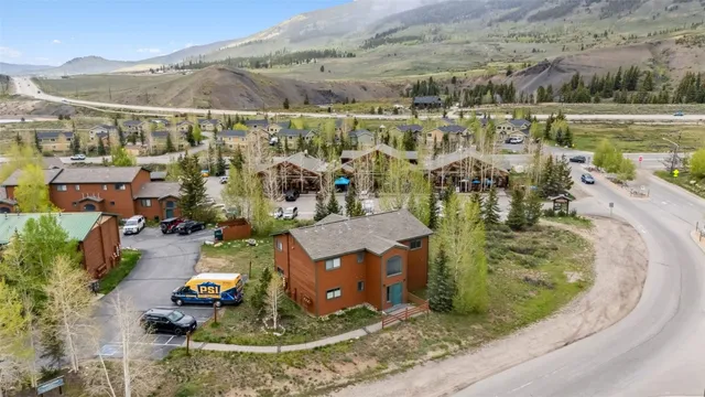 an aerial view of a house with a yard and lake view