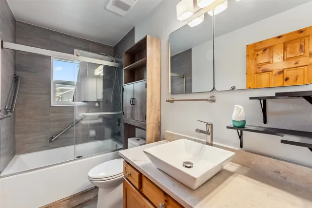 a bathroom with a sink a toilet and bathtub