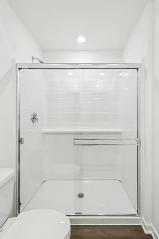 a bathroom with a shower and a toilet