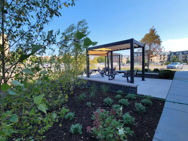 a view of a patio with couches table and chairs and potted plants
