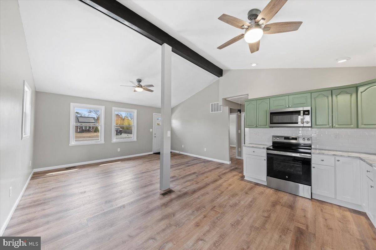 308 Apache Trail Browns Mills, NJ 08015 - Photo 11 of 34 a view of a kitchen with a stove wooden cabinets and a ceiling fan