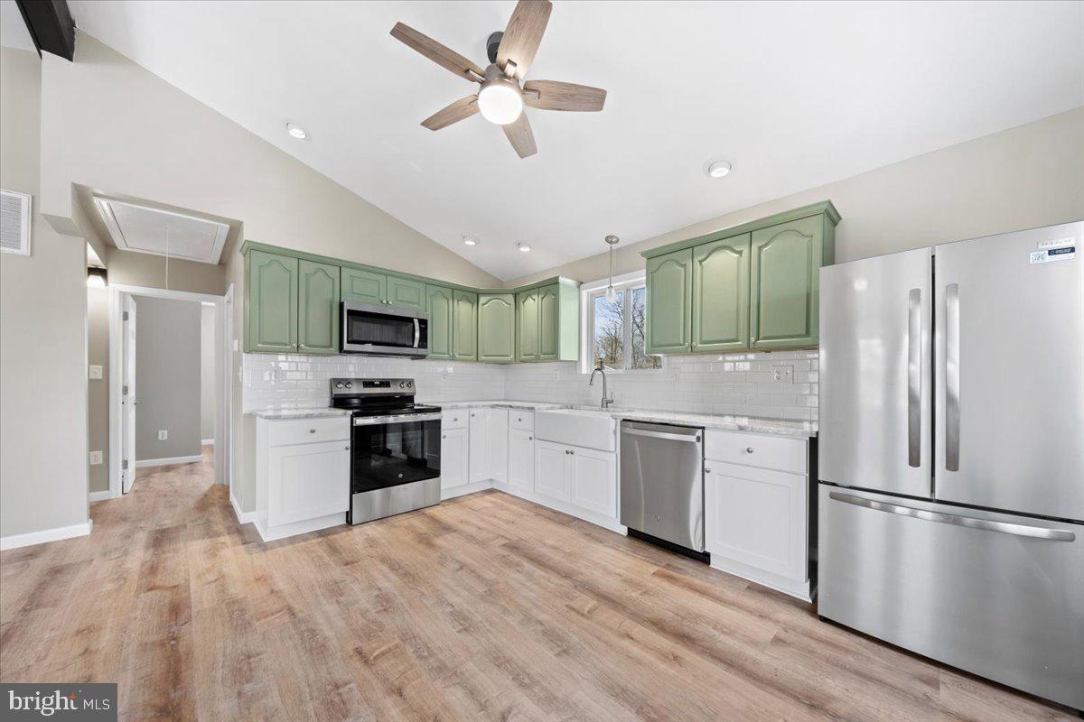 308 Apache Trail Browns Mills, NJ 08015 - Photo 14 of 34 a kitchen with a refrigerator a stove top oven a sink and dishwasher