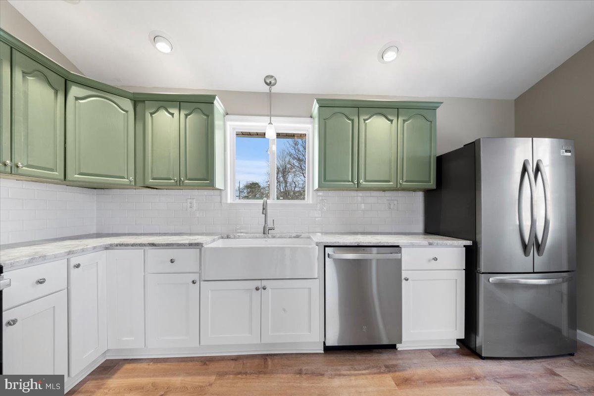 308 Apache Trail Browns Mills, NJ 08015 - Photo 16 of 34 a kitchen with stainless steel appliances granite countertop a refrigerator a sink and white cabinets