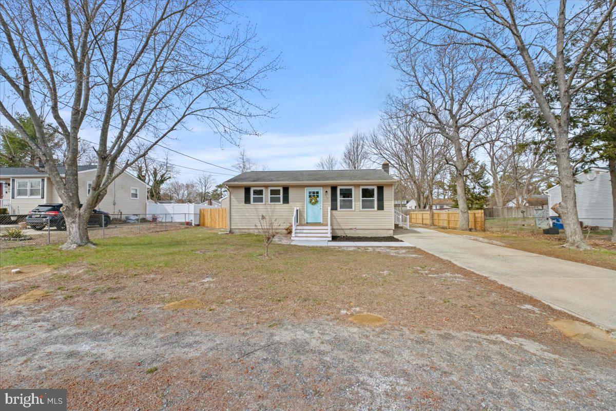308 Apache Trail Browns Mills, NJ 08015 - Photo 3 of 34 a front view of residential houses with yard and trees