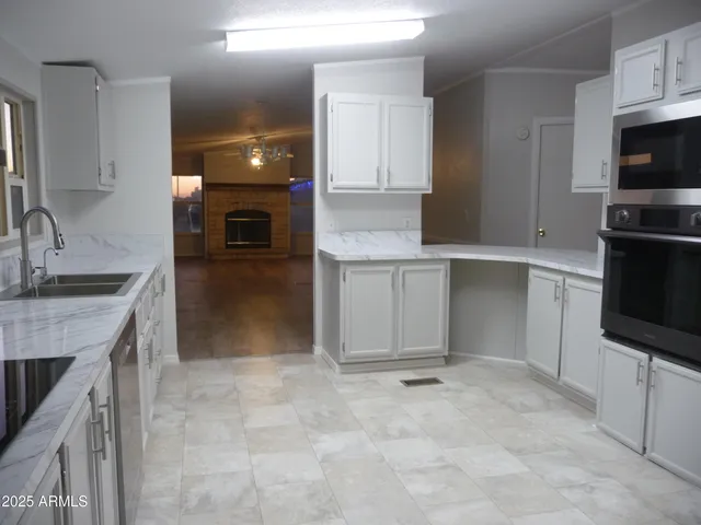 a spacious bathroom with a granite countertop sink a mirror and a