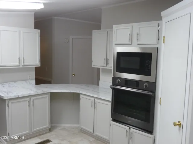 a kitchen with white cabinets and a sink
