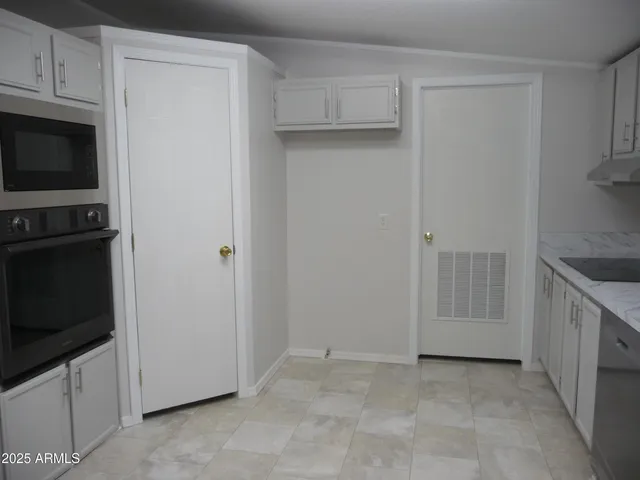 a kitchen with granite countertop a sink and cabinets
